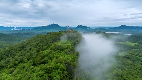 4K Hyperlapse of Mountain Peaks Covered in Fog with Signal Station Above