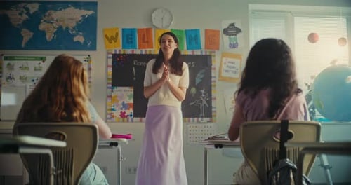 Female Teacher Calling Young Student to Board During Science Lesson in Modern Classroom