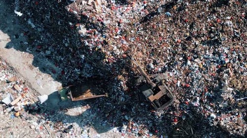 Large Waste Dump and Trash Truck with Garbage in Aerial Top View
