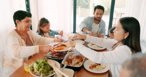 Family Meal Around Dining Table At Home
