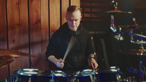 Drummer Performs Powerful Beats in a Studio Setting During Recording Session