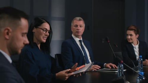 Speech Of Political Speaker At Meeting Room Of Business Center. Adult Smiling Woman In Suit Expla...