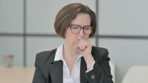 Mature Woman Coughing in Office Setting