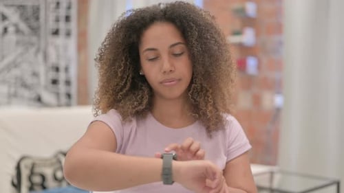 Young Adult Using Smart Watch Indoors