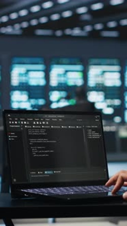 Typing Code On Laptop Computer in Workplace