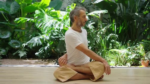 Man practicing bridge pose outdoors with energized focus