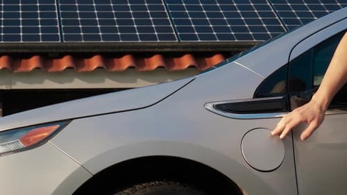 Electric Car Charging with Solar Panel Background