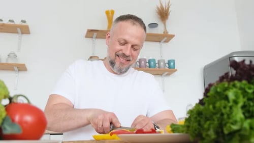 Man Chopping Vegetables in Bright Kitchen for Healthy Meal