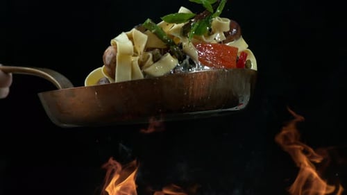 Pasta, Mushrooms and Greens Tossing in Frying Pan