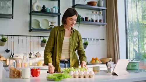 Woman Preparing Fresh Salad in Bright Modern Kitchen