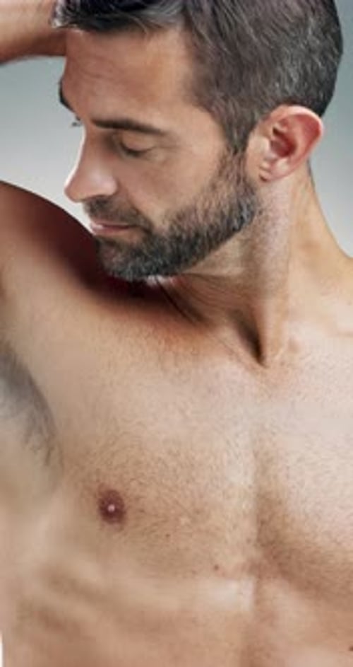 Happy man, face or hygiene with spray for fragrance, scent or aroma on a studio background