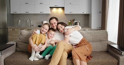 Happy Family Relaxing Together on Couch