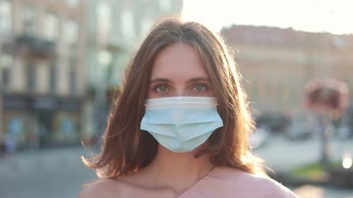 Close Up of Young Caucasian Woman Wearing Medical Mask on Face and Looking at Camera Pretty Female