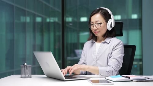 Woman Working on a Laptop in an Office