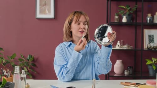 Slow Motion of Influencer Talking to Camera as She Applying Lipstick in Studio