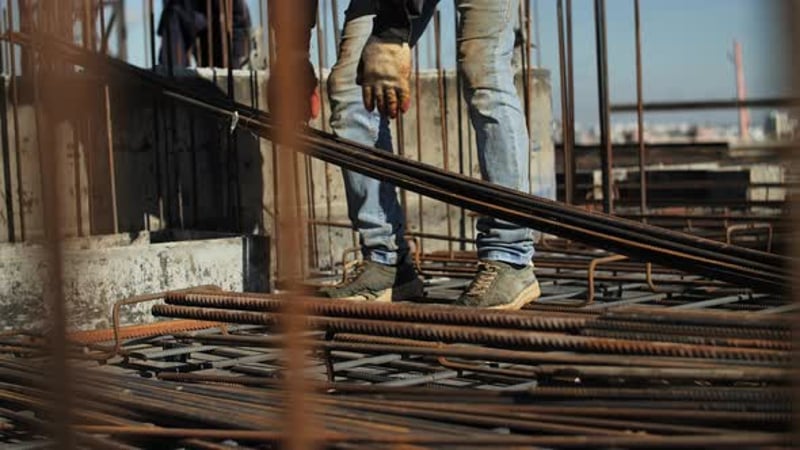 Construction Worker Adjusting Metal Support Prop on Building Site ...