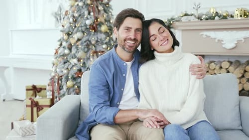 Webcam view. Portrait of happy married couple hugging in living room at home during winter New Year