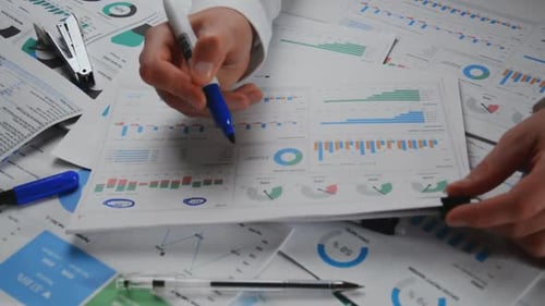 Hands Circulating Business Data With Blue Marker
