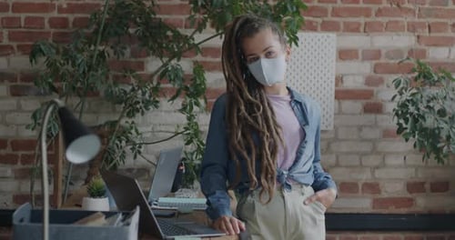 Portrait of Businesswoman Wearing Face Mask Standing in Office During Global Pandemic