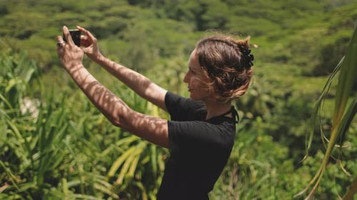 Young Woman Taking a Selfie with Smartphone in Tropical Forest