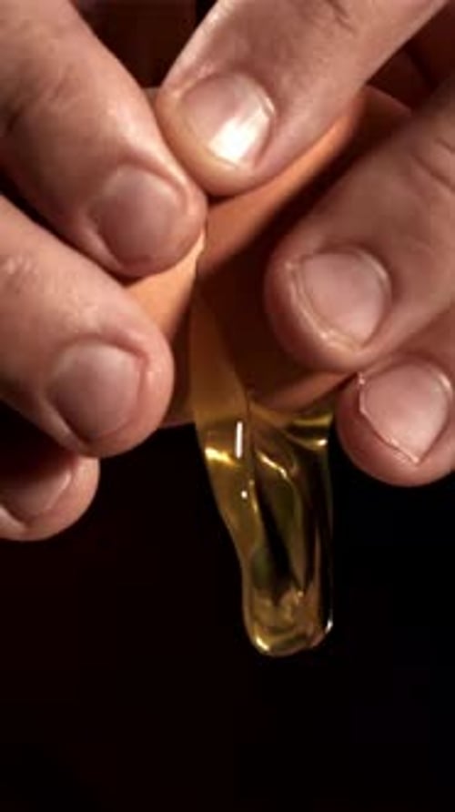 A Raw Egg Falls From a Man's Hands Filmed on a Highspeed Camera at 1000 Fps