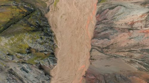Bird's eye view flying over narrow canyon, riverbed, Landmannalaugar, Iceland.