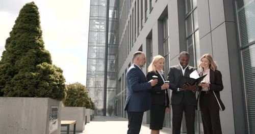 Business Team Discussing a Project Outdoors