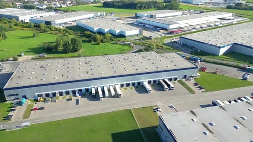 Logistics park with warehouse. Semi-trailers trucks standing on car parking and waiting for loading