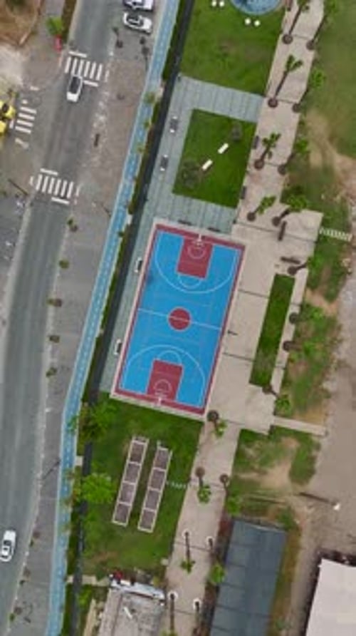 Vertical Video Basketball Court By the Mediterranean Sea With Players Shooting Hoops Against