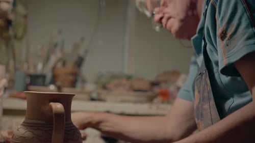 Senior Artist Making Vase in Studio