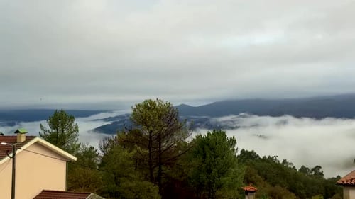 Foggy Landscape View of Mountains and Rural Homes