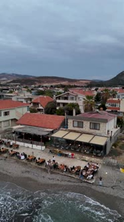 4K Drone Footage of a Seaside Venue with Outdoor Tables and Coastal View