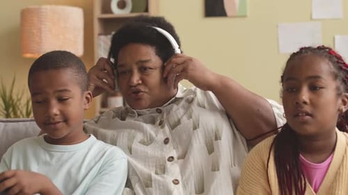 Family Fun Sharing Headphones on Couch