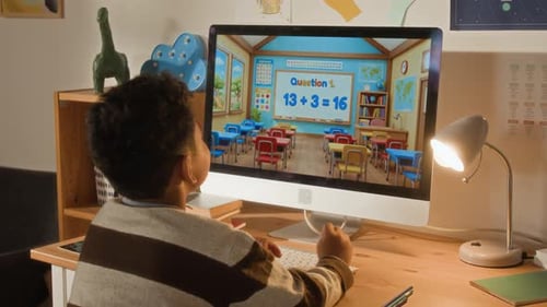 Black Boy Cheering while Doing Math Sums on Online App