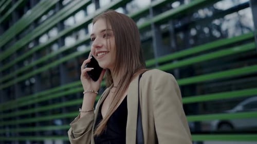 Woman Talking on Cell Phone in Urban Setting
