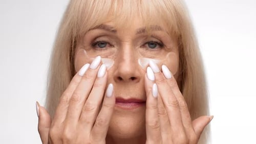 Senior Woman Using Skincare Eye Patches
