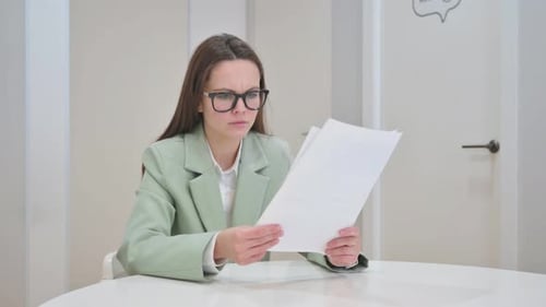 Business Woman Reading Documents Looking Unhappy