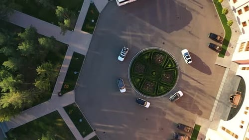 Cars Roll Around in Circles Near Buildings View From Above