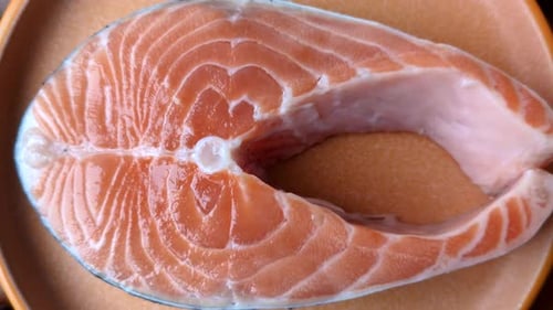 Fresh Salmon Steak Close-Up on Plate with Spices