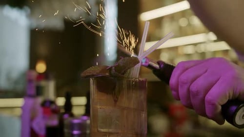 The Bartender Show in Restaurant Add Spices Into the Glass Fire Sparkles with Fire in Cocktail