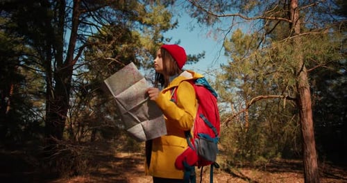 Backpacker Hiker Girl with Hiking Poles Using Authentic Paper Map in the Forest Hispanic Teenager in