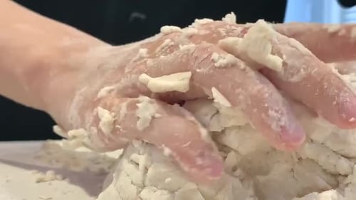 Close of up child's hands kneading dough. Baking has become a popular shelter in place activity duri