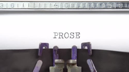 Prose word closeup being typing and centered on a sheet of paper on old vintage typewriter mech