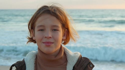 Teen Boy Looking at Camera By the Ocean
