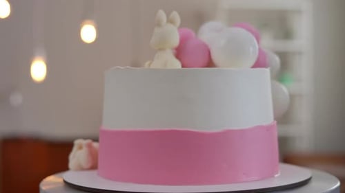 Decorated Birthday Cake with Bunnies and Balloons
