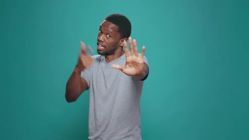 Young Adult Expressive Hand Gestures on Teal Background