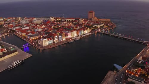 aerial drone image of the city of curacao in the caribbean at night