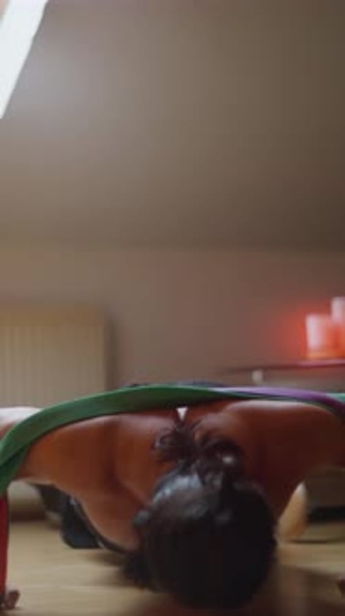 Man Doing Push-Ups and Squats with Resistance Bands