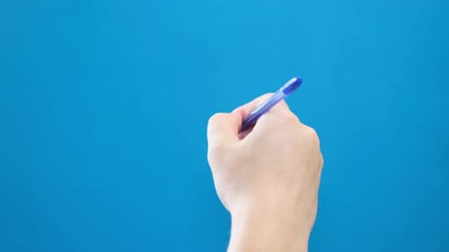 A Ballpoint Pen Writes on a Blue Background