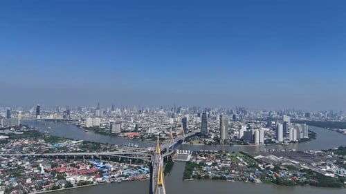 Aerial view of bustling cityscape under bright blue sky.